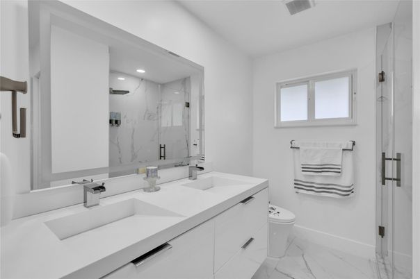 Bathroom, Dual Sink Vanities, Glass Shower, Interior, Marble, Marble Walls, Recessed Lighting