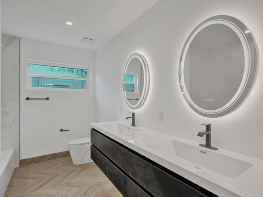 Bathroom, Dual Sink Vanities, Interior, Marble Walls, Recessed Lighting, Wood Texture Flooring