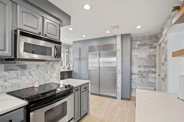 Interior, Kitchen, Marble Walls, Recessed Lighting, Stainless Steel Appliances
