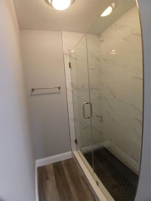 Bathroom, Glass Shower, Interior, Marble Walls, Recessed Lighting, Wood Texture Flooring