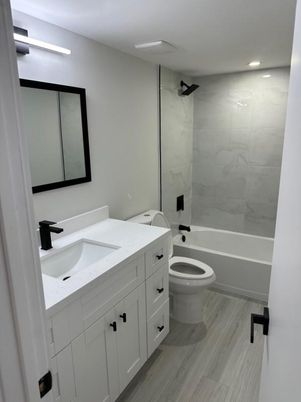 Bathroom, Dual Sink Vanities, Interior, Marble Walls, Recessed Lighting, Wood Texture Flooring