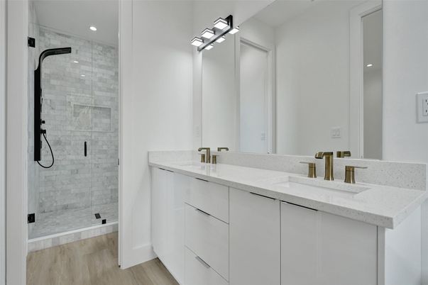 Bathroom, Dual Sink Vanities, Glass Shower, Interior, Recessed Lighting, Wood Texture Flooring