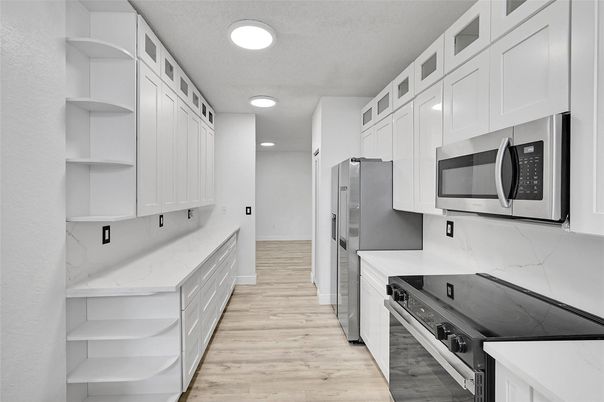 Interior, Kitchen, Marble Walls, Recessed Lighting, Stainless Steel Appliances, Wood Texture Flooring