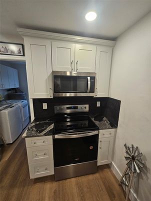 Interior, Kitchen, Recessed Lighting, Washer, Wood Texture Flooring