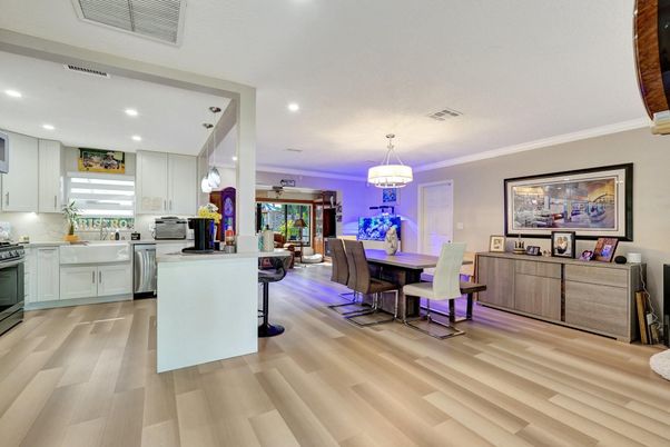 Chandelier, Dining room, Interior, Kitchen, Pendant Lights, Recessed Lighting, Stainless Steel Appliances, Wood Texture Flooring