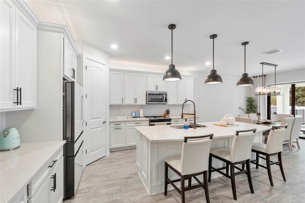 Dining room, Interior, Kitchen, Pendant Lights, Recessed Lighting, Stainless Steel Appliances, Wood Texture Flooring