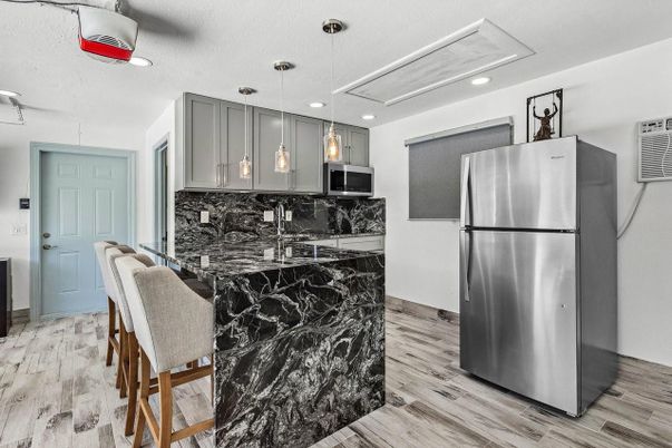 Interior, Kitchen, Marble Walls, Pendant Lights, Recessed Lighting, Stainless Steel Appliances, Wood Texture Flooring