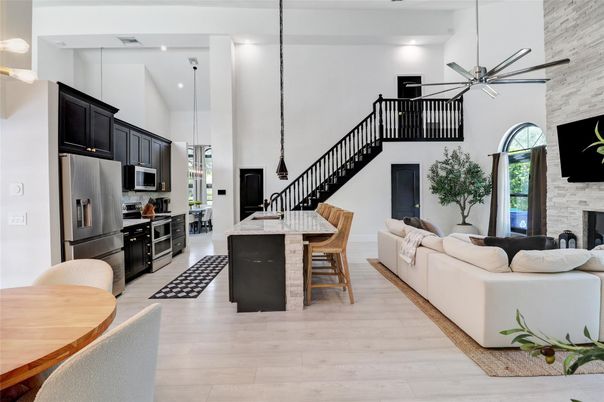 Fireplace, Interior, Kitchen, Living room, Pendant Lights, Recessed Lighting, Stainless Steel Appliances, Stone Walls, Wood Texture Flooring