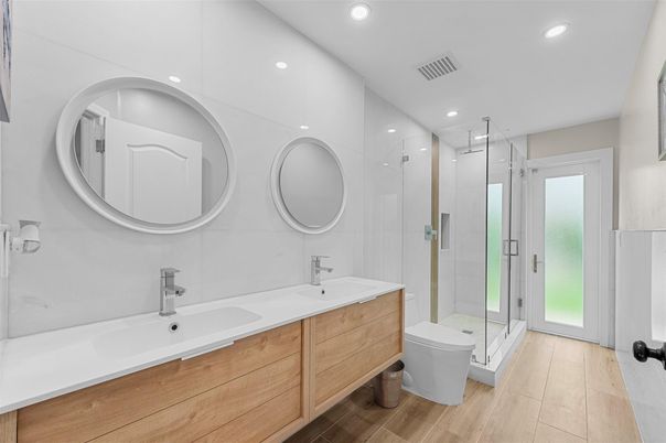 Bathroom, Dual Sink Vanities, Glass Shower, Interior, Recessed Lighting, Wood Texture Flooring