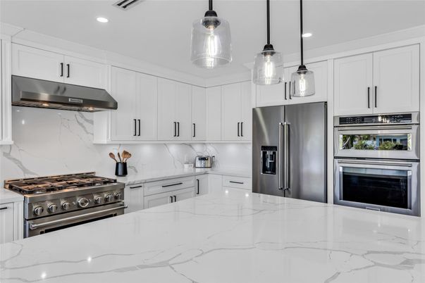Interior, Kitchen, Marble Walls, Pendant Lights, Recessed Lighting, Stainless Steel Appliances