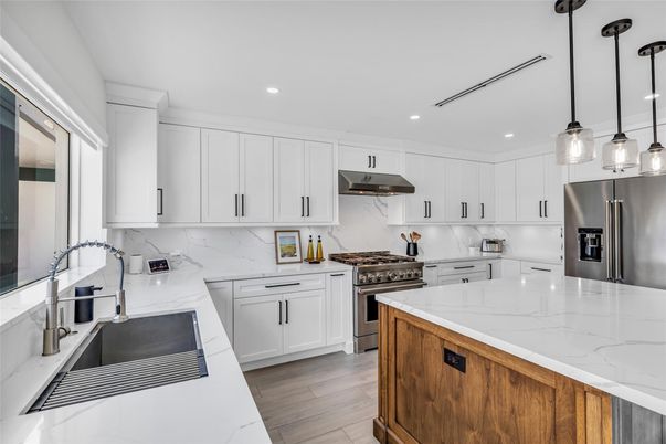 Interior, Kitchen, Marble Walls, Pendant Lights, Recessed Lighting, Stainless Steel Appliances, Wood Texture Flooring