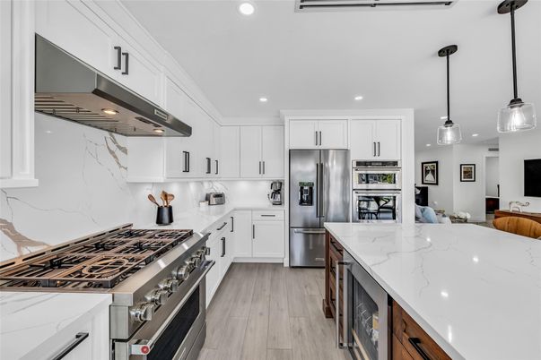 Interior, Kitchen, Marble Walls, Pendant Lights, Recessed Lighting, Stainless Steel Appliances, Wood Texture Flooring
