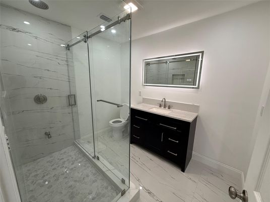 Bathroom, Dual Sink Vanities, Glass Shower, Interior, Marble, Marble Walls, Recessed Lighting