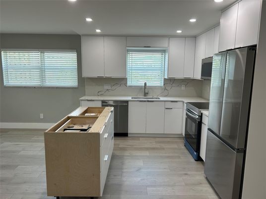Interior, Kitchen, Marble Walls, Recessed Lighting, Stainless Steel Appliances, Wood Texture Flooring