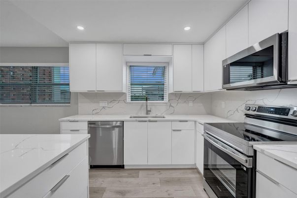 Interior, Kitchen, Marble Walls, Recessed Lighting, Stainless Steel Appliances, Wood Texture Flooring