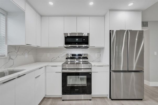 Interior, Kitchen, Marble Walls, Recessed Lighting, Stainless Steel Appliances, Wood Texture Flooring