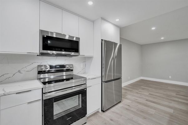 Interior, Kitchen, Marble Walls, Recessed Lighting, Stainless Steel Appliances, Wood Texture Flooring