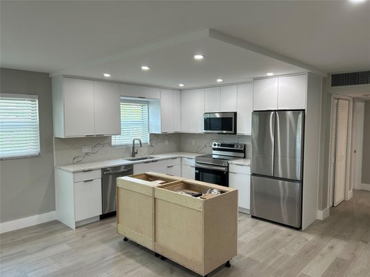 Interior, Kitchen, Marble Walls, Recessed Lighting, Stainless Steel Appliances, Wood Texture Flooring