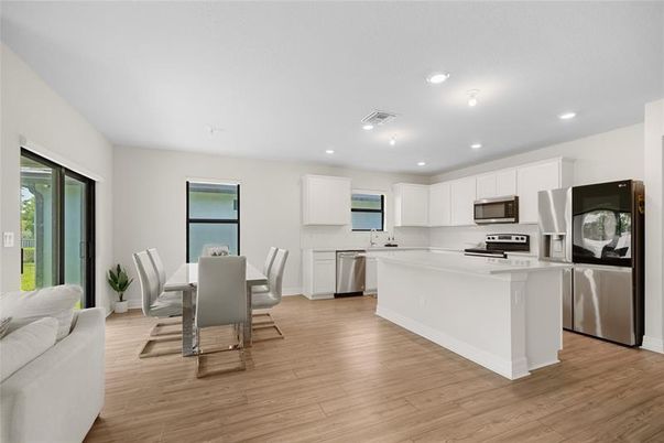 Dining room, Interior, Kitchen, Recessed Lighting, Stainless Steel Appliances, Wood Texture Flooring