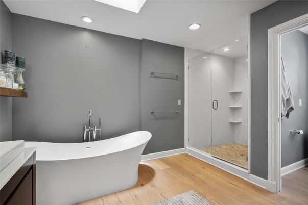 Bathroom, Free Standing Baths, Glass Shower, Interior, Recessed Lighting, Wood Texture Flooring