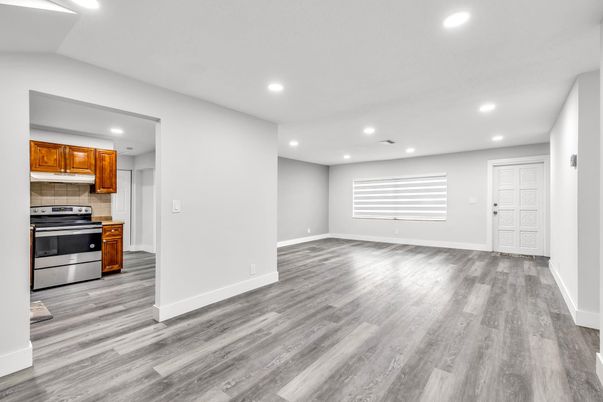 Empty room, Interior, Kitchen, Recessed Lighting, Stainless Steel Appliances, Wood Texture Flooring