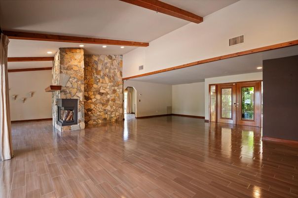 Empty room, Fireplace, Interior, Recessed Lighting, Stone Walls, Wooden Beams, Wood Texture Flooring