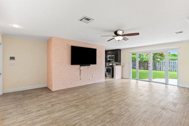 Empty room, Interior, Kitchen, Recessed Lighting, Stainless Steel Appliances, Stone Walls, Wood Texture Flooring