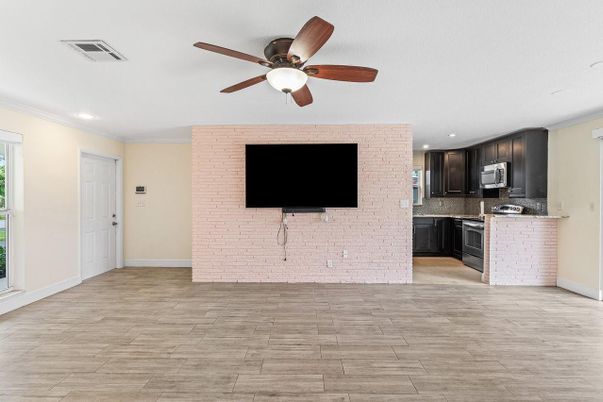 Empty room, Interior, Kitchen, Recessed Lighting, Stainless Steel Appliances, Wood Texture Flooring
