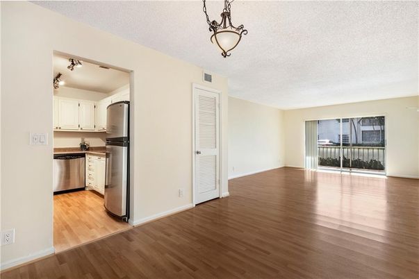 Empty room, Interior, Kitchen, Pendant Lights, Stainless Steel Appliances, Wood Texture Flooring