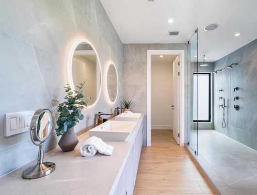 Bathroom, Dual Sink Vanities, Glass Shower, Interior, Marble Walls, Recessed Lighting, Wood Texture Flooring