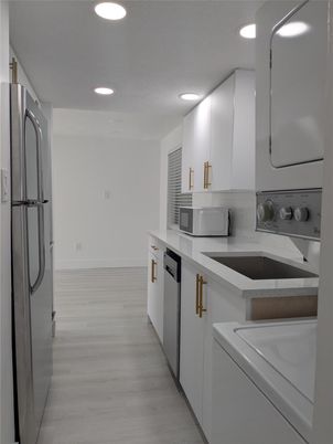 Interior, Kitchen, Recessed Lighting, Washer, Wood Texture Flooring