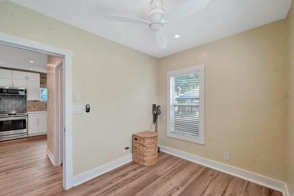 Empty room, Interior, Kitchen, Recessed Lighting, Stainless Steel Appliances, Wood Texture Flooring