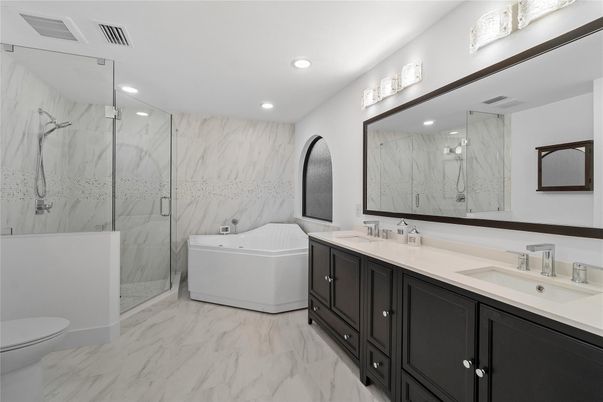 Bathroom, Dual Sink Vanities, Glass Shower, Interior, Marble, Marble Walls, Recessed Lighting
