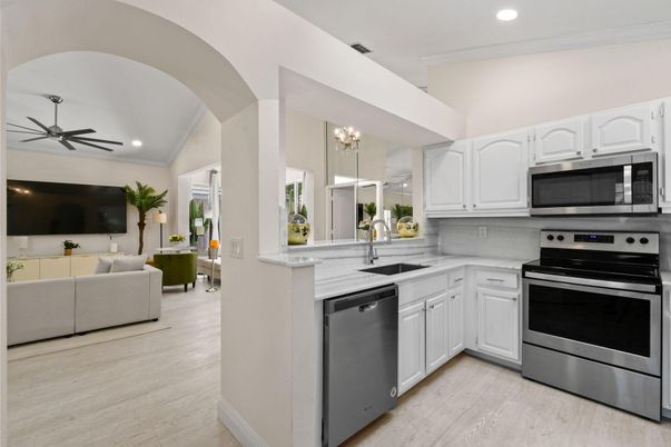 Chandelier, Interior, Kitchen, Living room, Recessed Lighting, Stainless Steel Appliances, Wood Texture Flooring