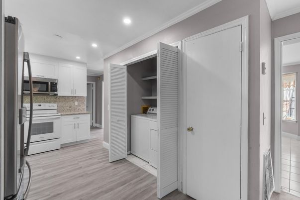 Interior, Kitchen, Recessed Lighting, Washer, Wood Texture Flooring