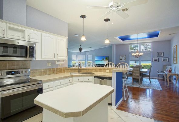 Chandelier, Dining room, Interior, Kitchen, Pendant Lights, Stainless Steel Appliances, Wood Texture Flooring