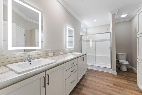 Bathroom, Dual Sink Vanities, Glass Shower, Interior, Recessed Lighting, Wood Texture Flooring