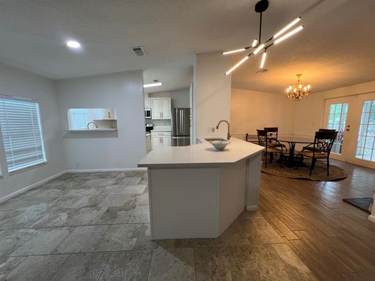 Chandelier, Dining room, Interior, Kitchen, Pendant Lights, Recessed Lighting, Stainless Steel Appliances, Wood Texture Flooring