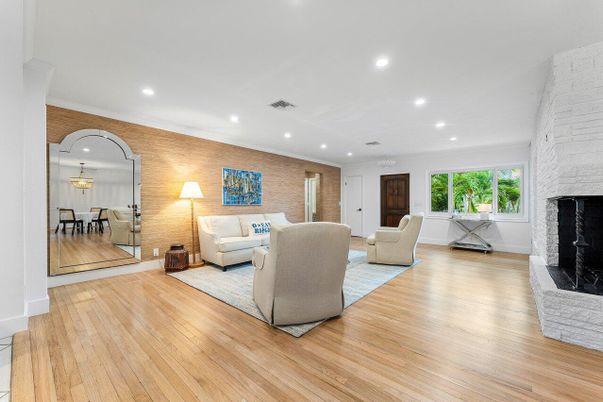 Dining room, Fireplace, Interior, Living room, Recessed Lighting, Stone Walls, Wood Texture Flooring