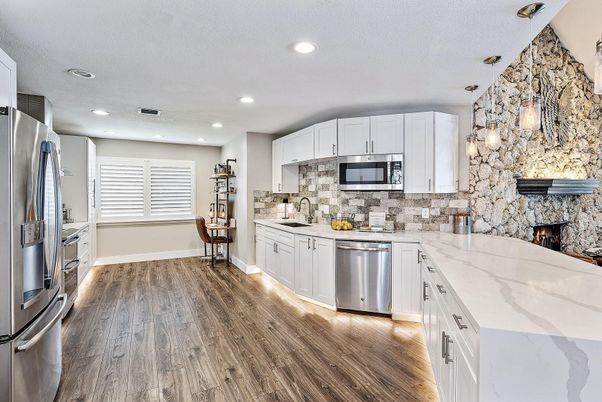Fireplace, Interior, Kitchen, Pendant Lights, Recessed Lighting, Stainless Steel Appliances, Stone Walls, Wood Texture Flooring