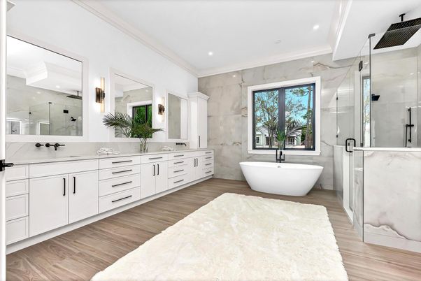 Bathroom, Dual Sink Vanities, Free Standing Baths, Glass Shower, Interior, Marble Walls, Recessed Lighting, Wood Texture Flooring