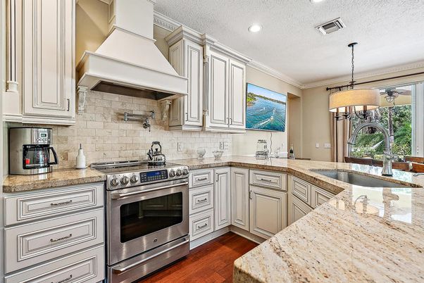 Chandelier, Interior, Kitchen, Pendant Lights, Recessed Lighting, Stainless Steel Appliances, Stone Walls, Wood Texture Flooring