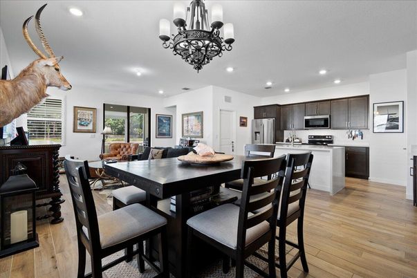 Chandelier, Dining room, Interior, Kitchen, Recessed Lighting, Stainless Steel Appliances, Wood Texture Flooring