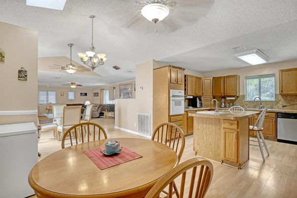 Chandelier, Dining room, Interior, Kitchen, Stainless Steel Appliances, Wood Texture Flooring