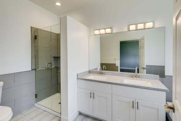 Bathroom, Dual Sink Vanities, Glass Shower, Interior, Recessed Lighting, Wood Texture Flooring