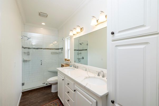 Bathroom, Dual Sink Vanities, Glass Shower, Interior, Recessed Lighting, Wood Texture Flooring