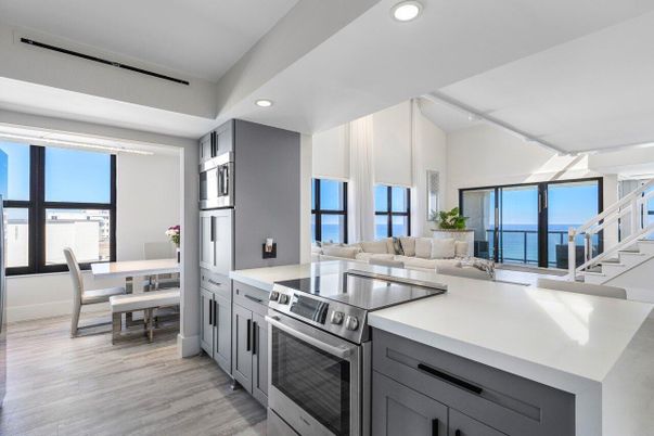 Dining room, Interior, Kitchen, Living room, Recessed Lighting, Stainless Steel Appliances, Water, Wood Texture Flooring