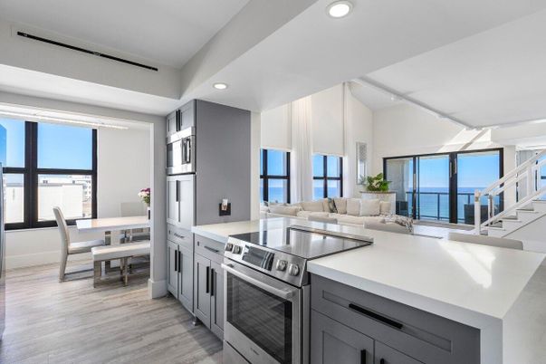 Dining room, Interior, Kitchen, Living room, Recessed Lighting, Stainless Steel Appliances, Water, Wood Texture Flooring