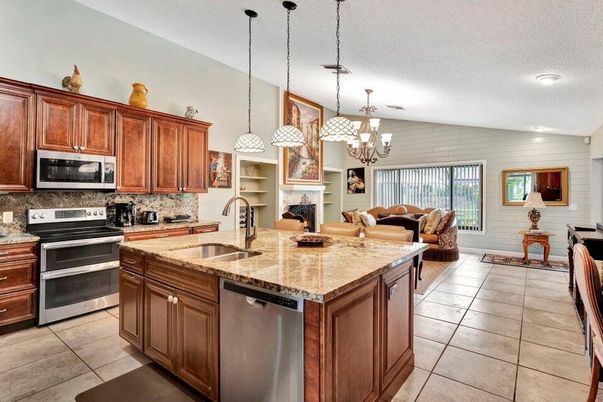 Chandelier, Fireplace, Interior, Kitchen, Living room, Pendant Lights, Recessed Lighting, Stainless Steel Appliances