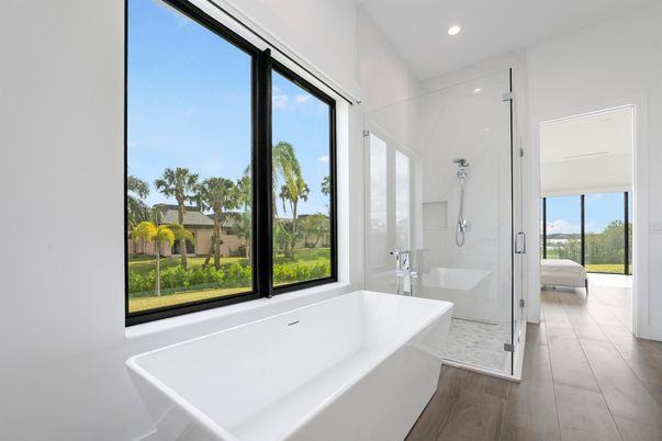 Bathroom, Free Standing Baths, Glass Shower, Interior, Marble Walls, Recessed Lighting, Wood Texture Flooring